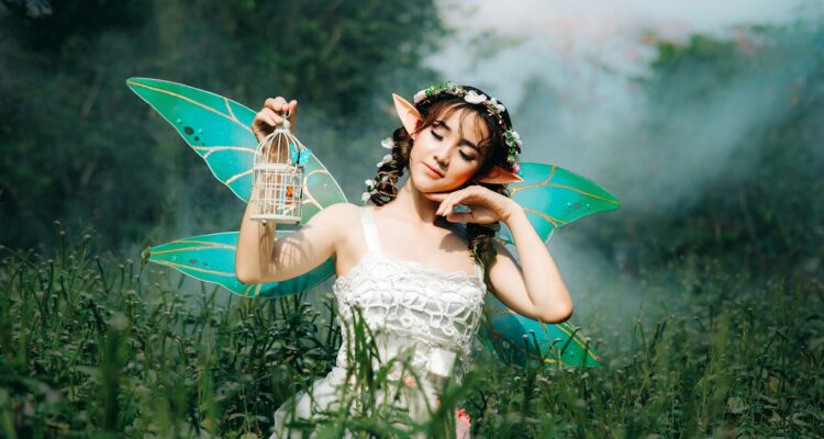 woman in white dress wearing green fairy wings