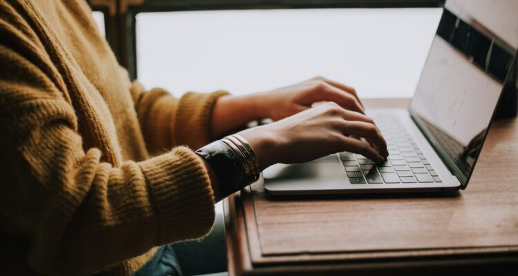 person sitting front of laptop