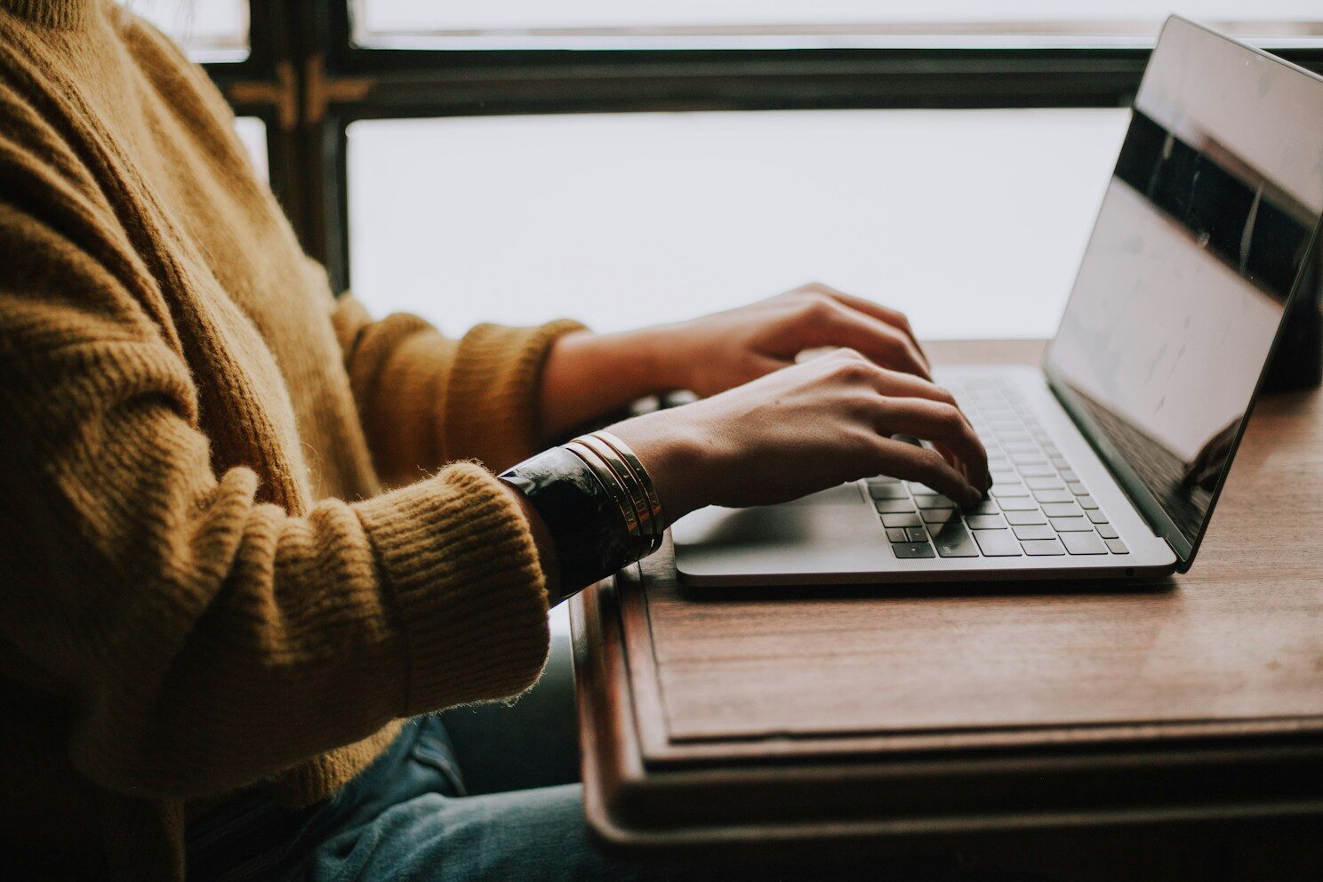 person sitting front of laptop